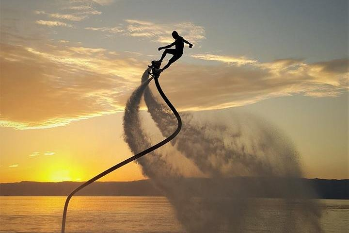 Soar above the calm waters at Palm Jumeirah feeling the rush as you master the flyboard all against a stunning sunset backdrop that highlights the beauty of Dubai’s coastline.